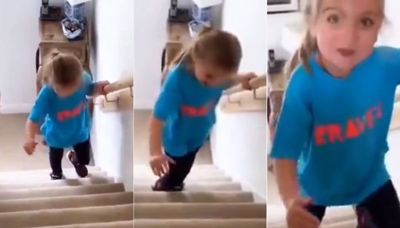 Little girl with cerebral palsy walks up the stairs for first time