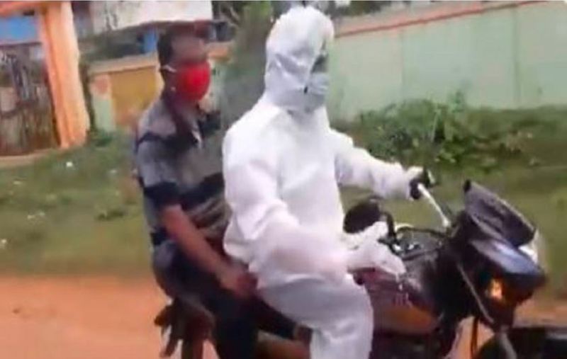 Wearing PPE Kit TMC leader Takes man to hospital on Bike