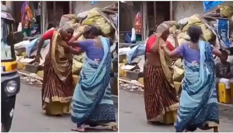 Two elderly women dance to Asha Bhosle's hit song  on a street