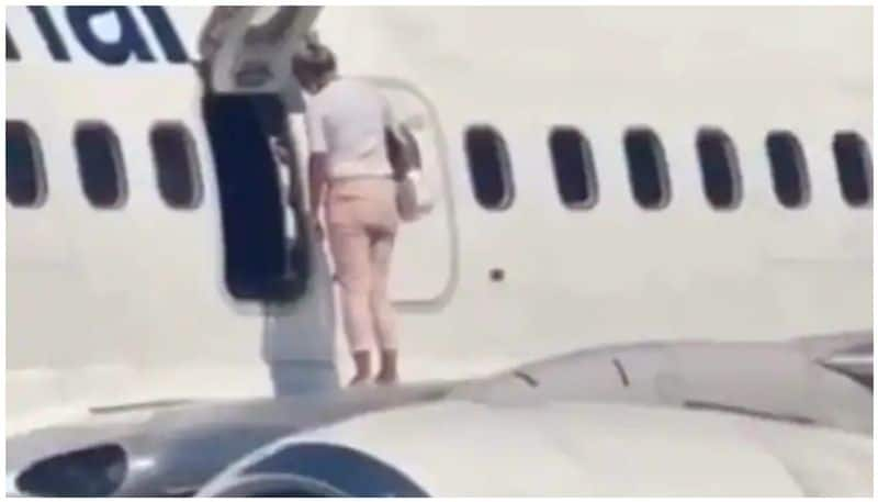 Woman Walks Onto Airplane Wing After Complaining She's Too Hot