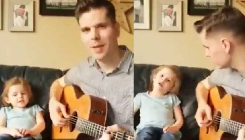 Little girl sings with her father in beautiful home concert