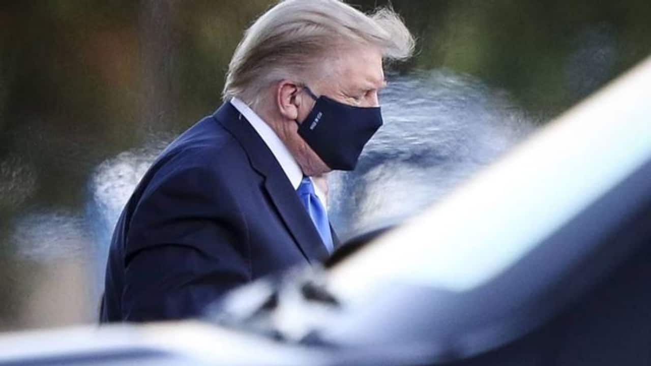'Infected' Donald Trump steps out on to the streets to meet 'patriots'