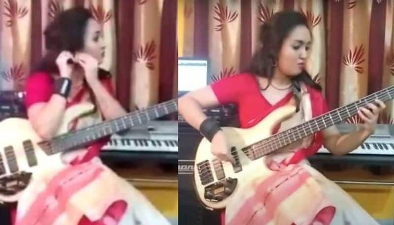 Video of saree clad musician playing on bass guitar