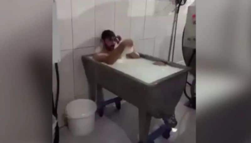 video of man takes bath in milk