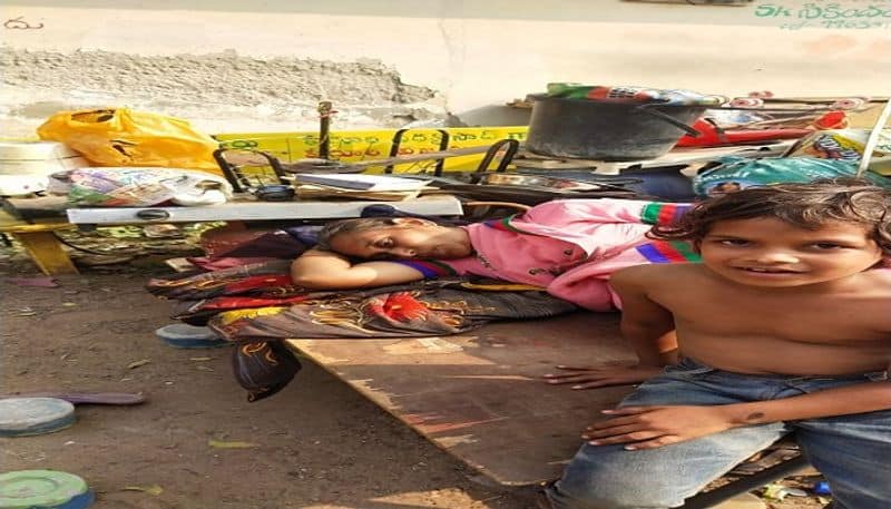 Woman with her children on the road at Vijayawada in Krishna district