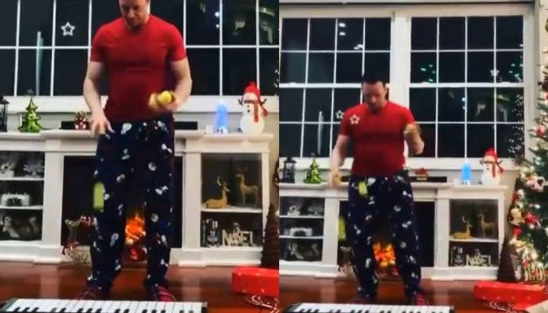 man plays christmas carol on keyboard by tennis balls