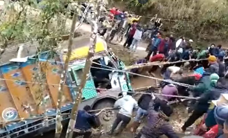 People pulling truck out of the gorge with the help of ropes in nagaland ckm