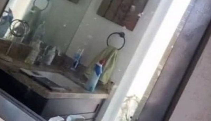 woman and family together found hidden room behind bathroom mirror of their new home