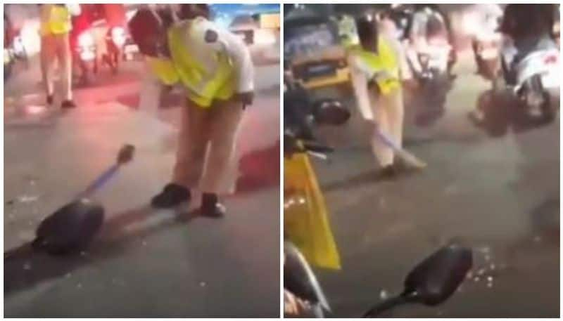 Woman traffic police constable sweeps road to remove broken glasses after accident in Pune