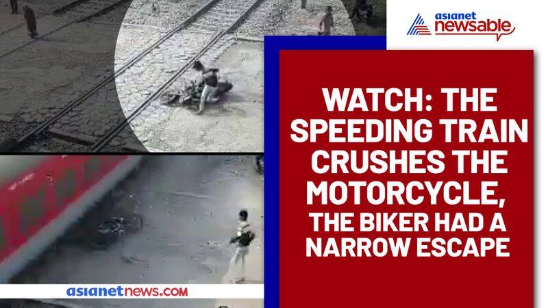 Mans close brush with death, bike crushed by a speeding train, Video goes viral - gps