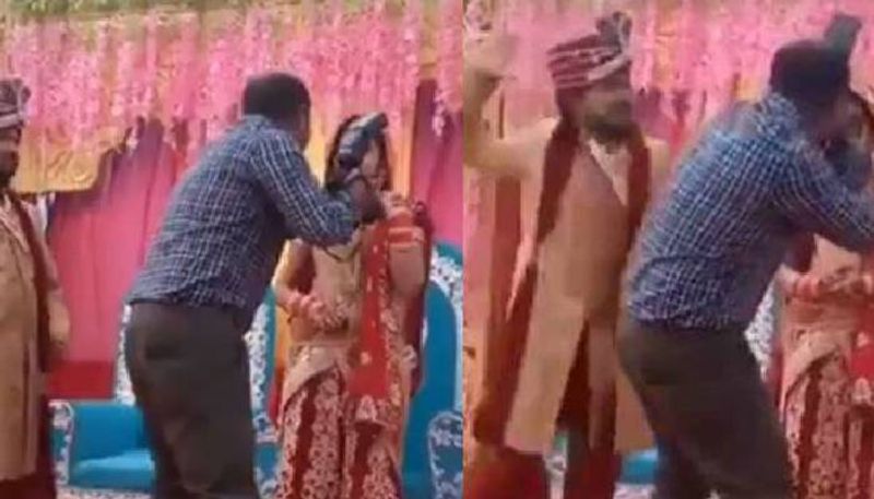 Groom smacks cameraman during wedding photoshoot