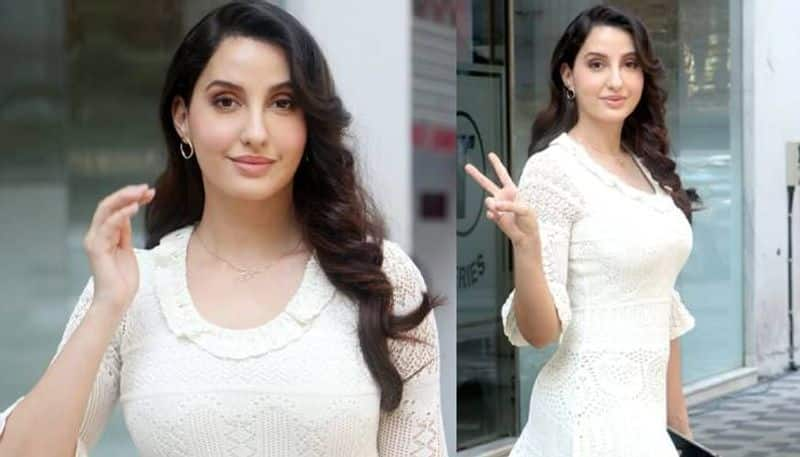 Nora Fatehi in a white dress and luxurious bag