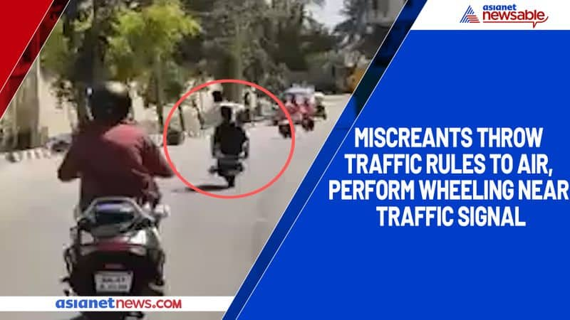 Miscreants throw traffic rules to air, perform wheeling near traffic signal-ycb