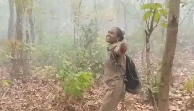 video in which woman forest officer dancing in rain