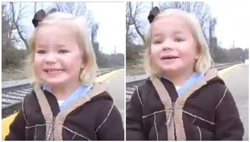 Girl shows pure joy after seeing train for the first time.