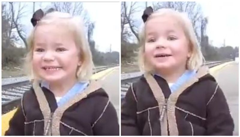 Girl shows pure joy after seeing train for the first time.