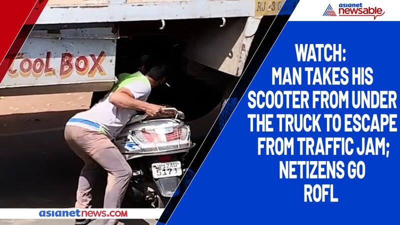 Watch Man takes his scooter from under the truck to escape from traffic jam; netizens go ROFL-tgy