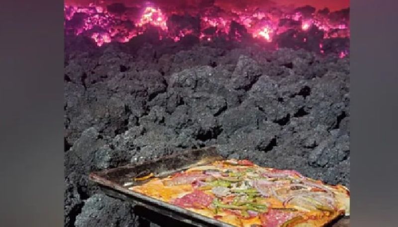 man makes pizza on active volcano