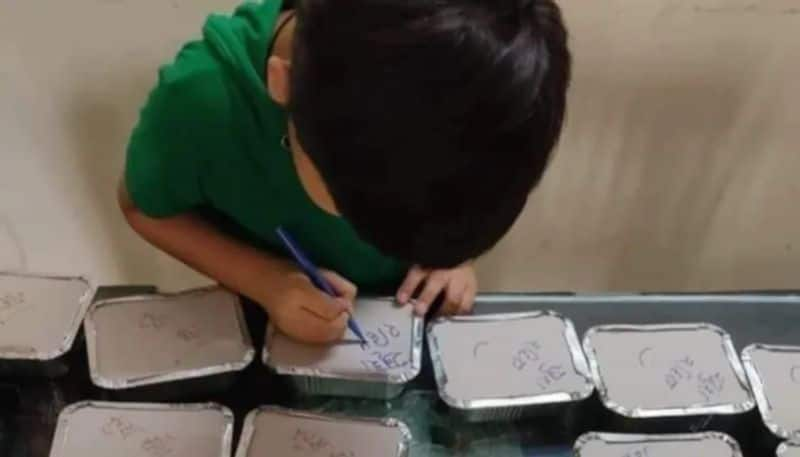 Boy writes be happy in every food packet for covid patients