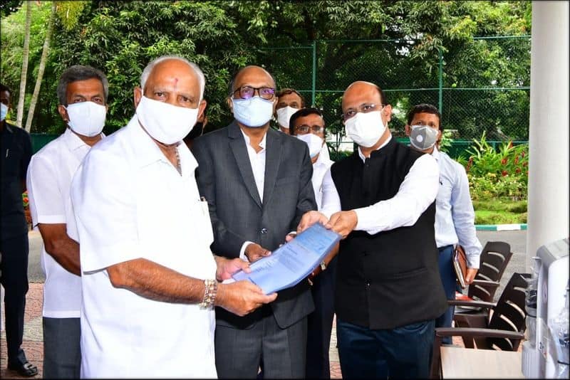 CM BS Yediyurappa received cheque essential medical supplies from TVS Motor Company ckm