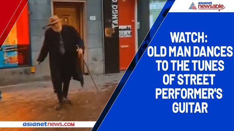 Watch Old man dances to the tunes of street performer's guitar-tgy