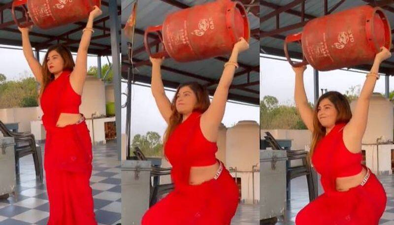 Saree clad Woman Performing Squats with LPG Cylinder