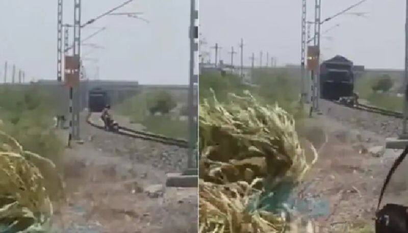 shocking video in which man doing stunts on railway tracks and suddenly train comes