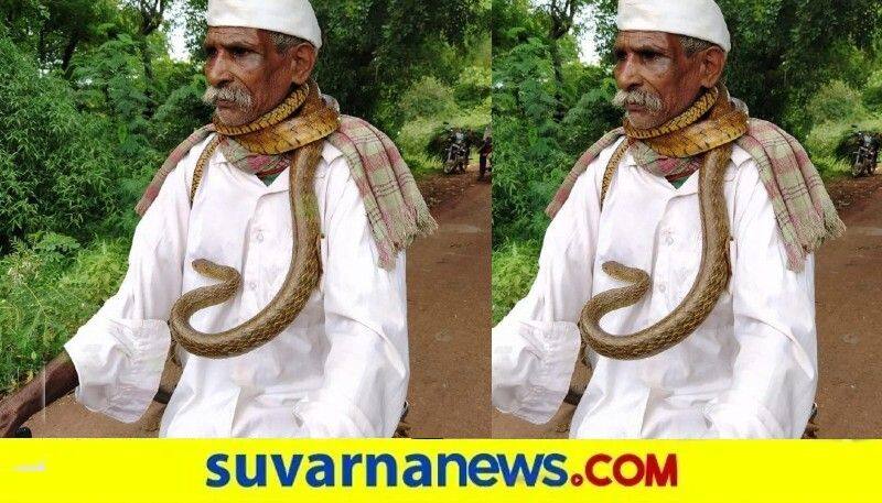 Old man wraps snake around his neck and rides a cycle  in belagavi snr