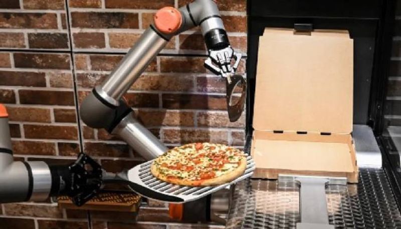 Pizza Cooked by a Robot in a restaurant