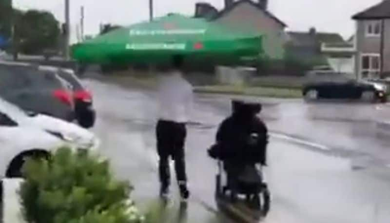 Cafe worker helps patron who uses a wheelchair in heavy rain; Watch Viral Video - gps