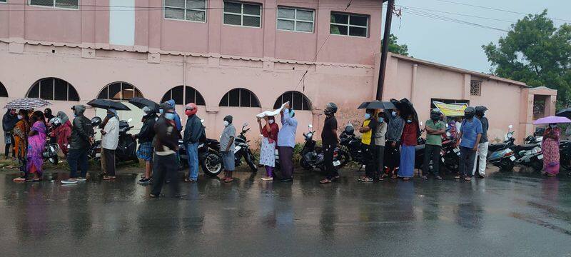 People standing on rain for corona vaccination at covai