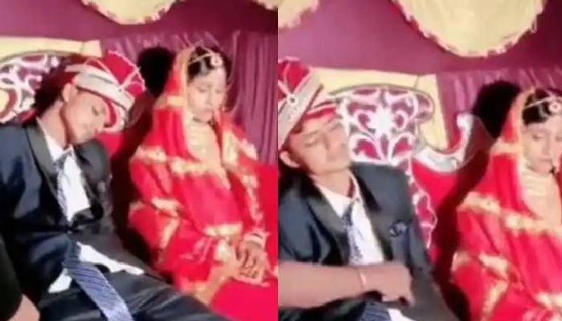 Groom falls asleep next to the bride on the wedding stage