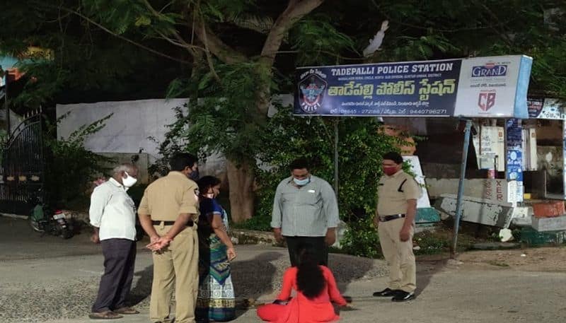 woman attempt to commit suicide by pouring petrol in front of police station, guntur - bsb