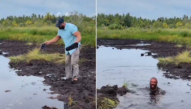 Watch Man gets submerged in muddy water while crossing a swamp; watch viral video-tgy