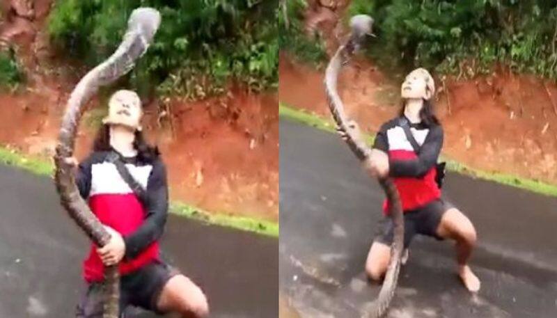 Woman catches giant snake with bare hands