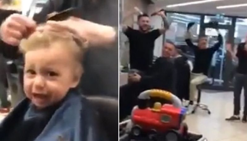 Barbers sing for anxious little boy during his haircut