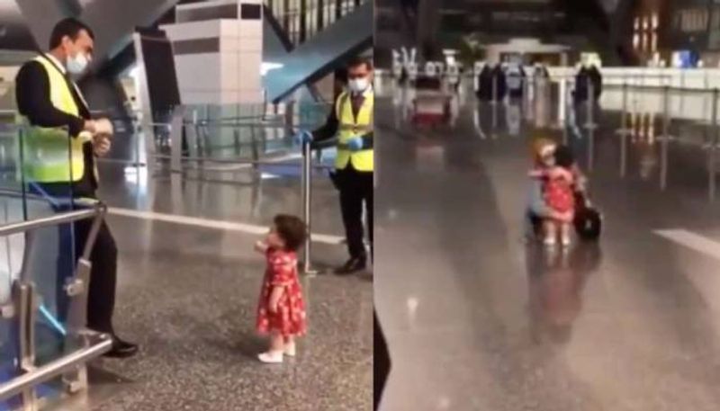 little girl asking permission from airport officers to hug aunt