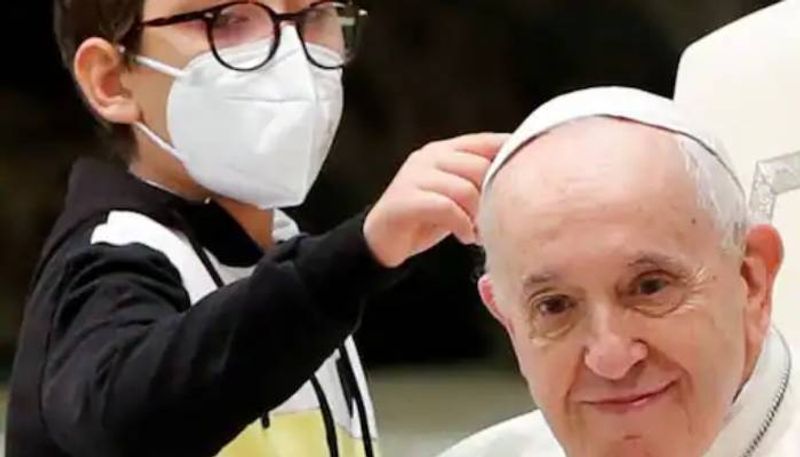 boy tries  steals Pope Francis's cap