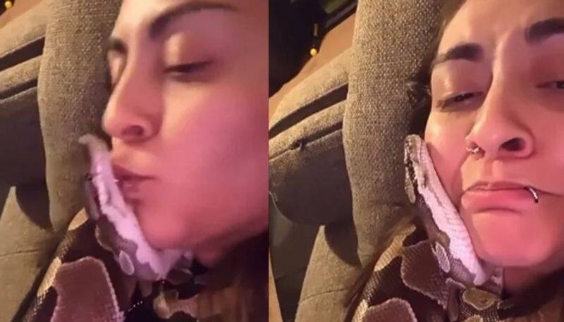 Girl cuddles and kisses pet snake in viral video