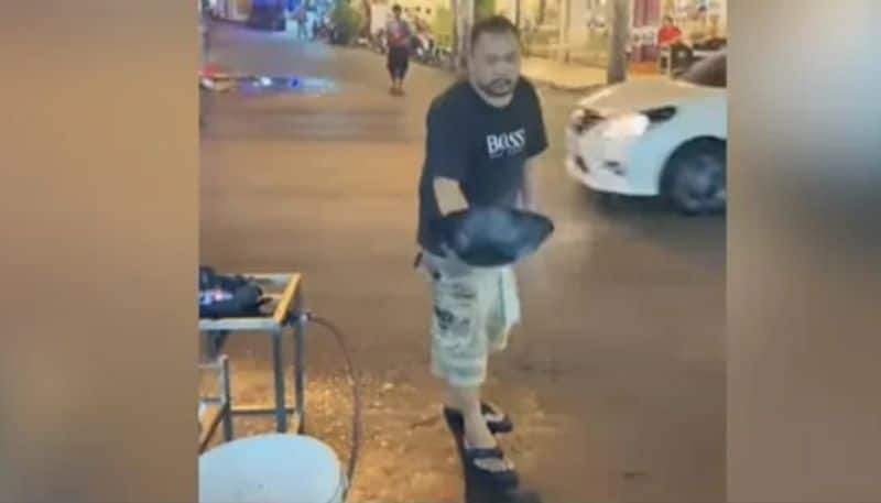 Street Vendor Tosses Food Across  Road And it Lands Perfectly