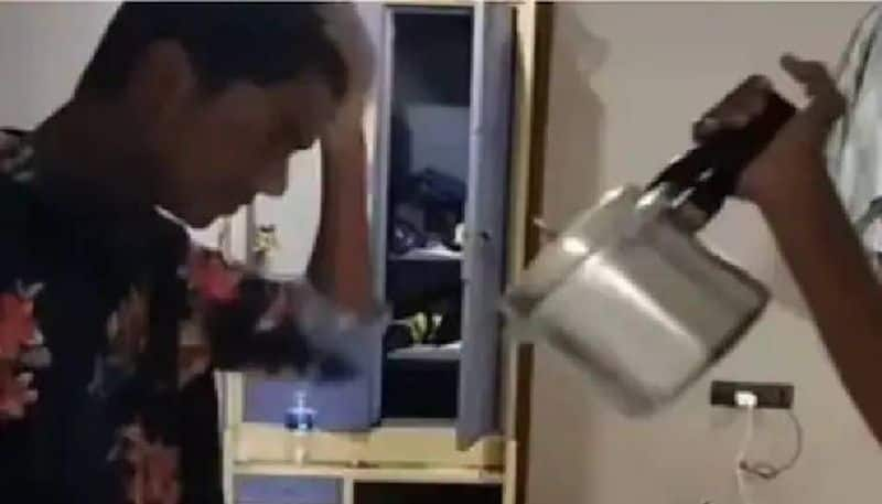 man using pressure cooker to dry his hair