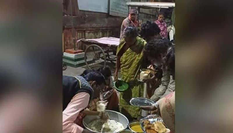 woman distributes food for homeless people after her brothers wedding reception