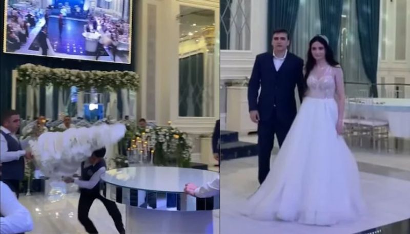 Bride and groom shocked as hotel staff drops wedding cake by mistake in viral video