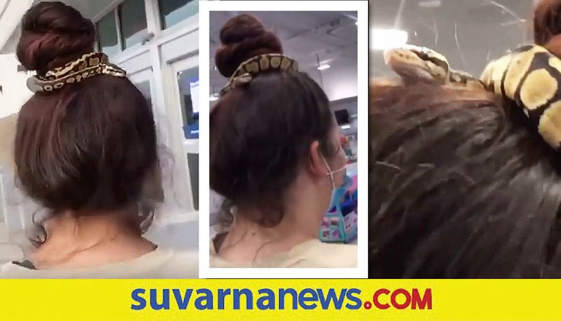 woman uses snake as her hairband while shopping akb