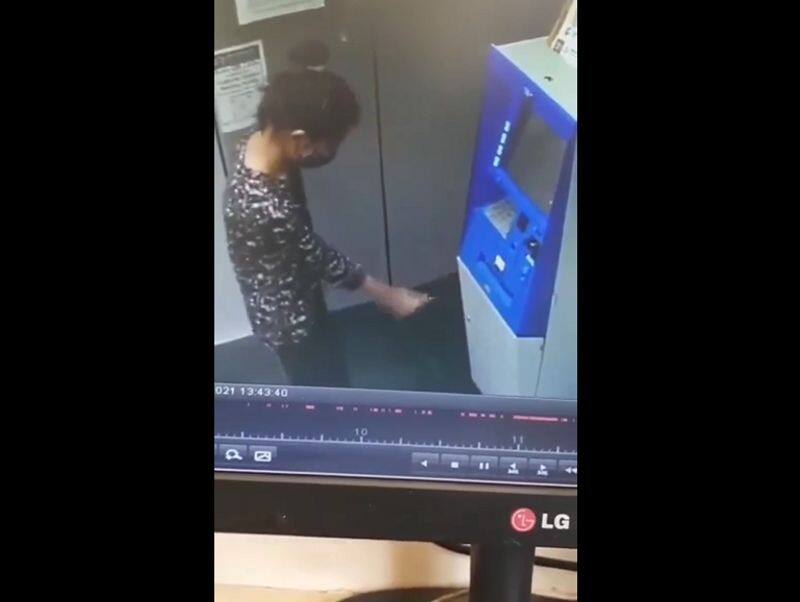 girl dances while withdrawing money in ATM