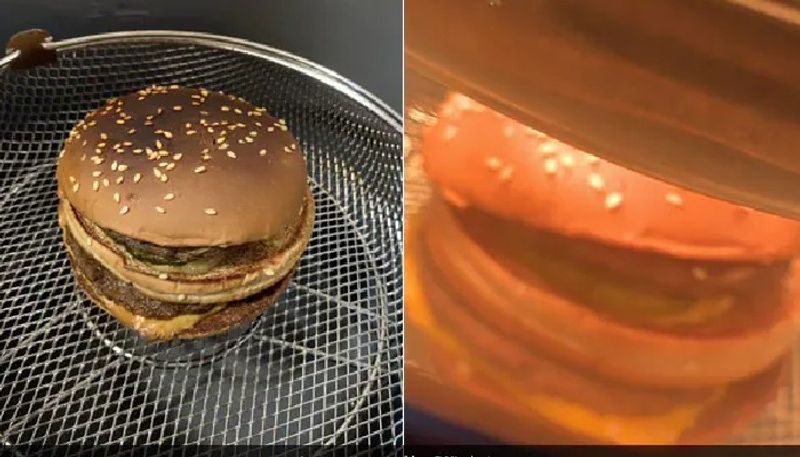 man prepares burger inside air fryer by using two hours