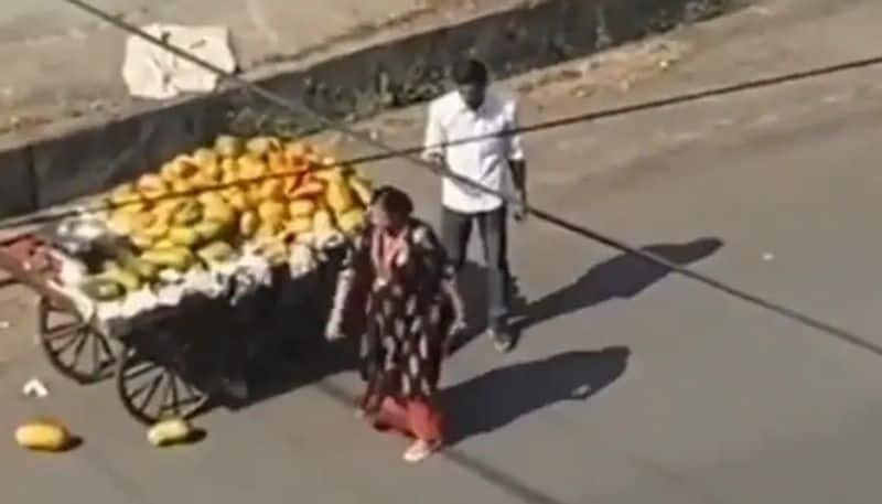 woman throws papayas after fruit vendors cart hits her car