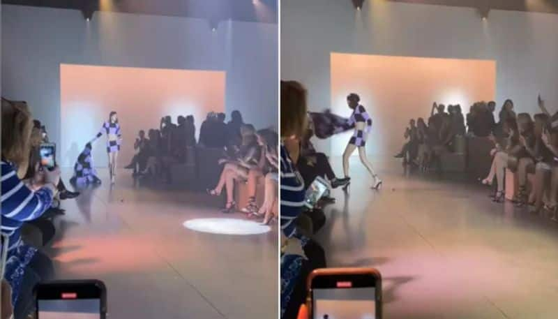 Model Hits Audience Member With Her Coat In Bizarre Video