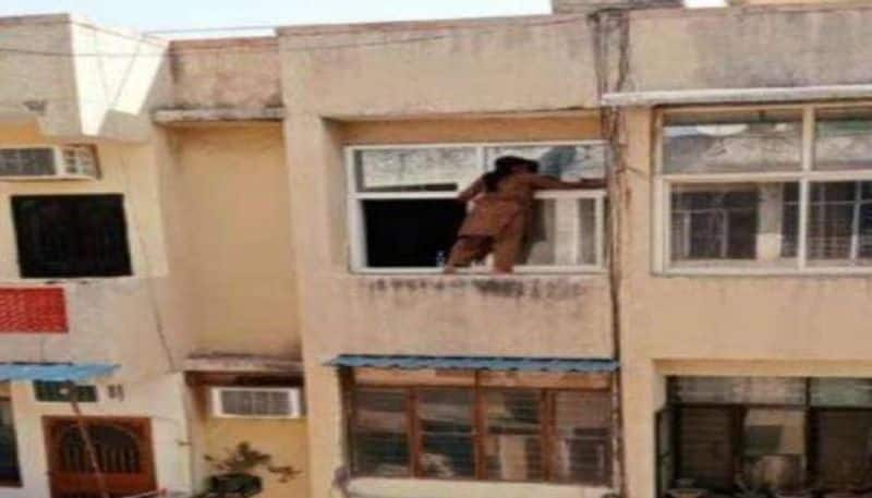 viral video woman cleaning window on a fourth floor railing