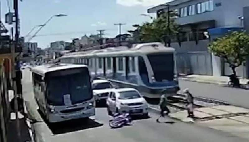 biker saves elderly woman from being hit by a tram